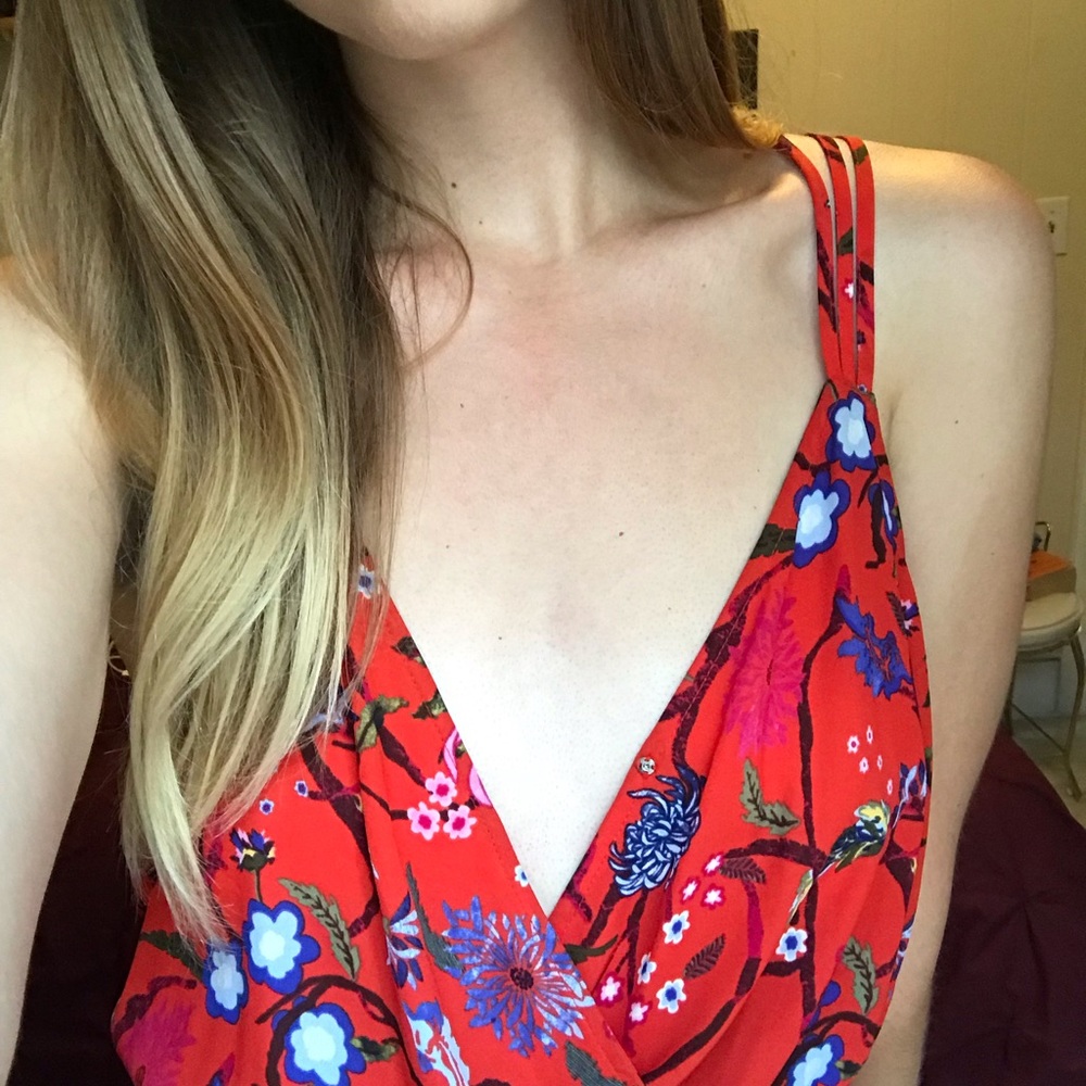 Red floral high-low romper with a train